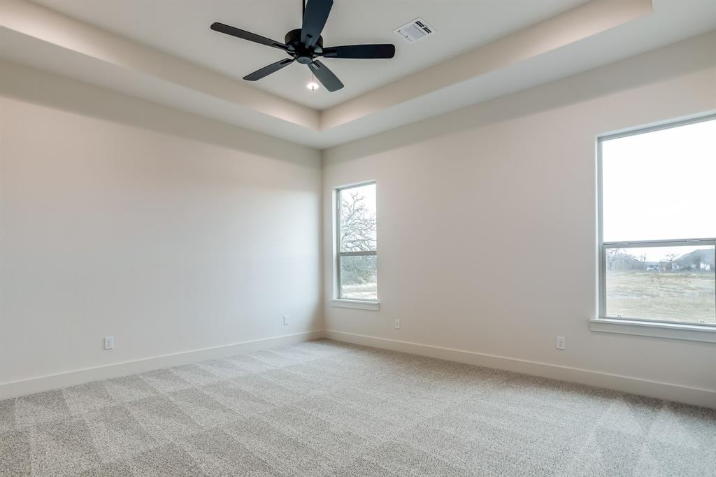 128 Prairie Winds Drive Poolville, TX 76487 - Photo 16 of 40 an empty room with windows and fan