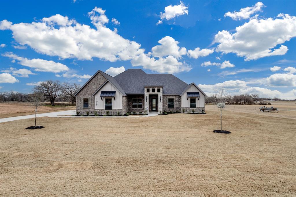128 Prairie Winds Drive Poolville, TX 76487 - Photo 2 of 40 a front view of a house with street