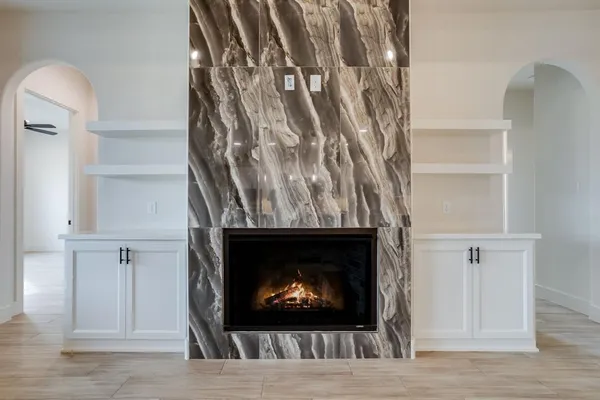 a view of a hallway with entryway and wooden floor