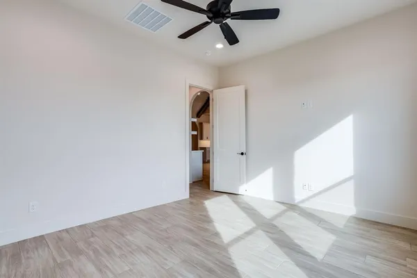 an empty room with a window and a kitchen