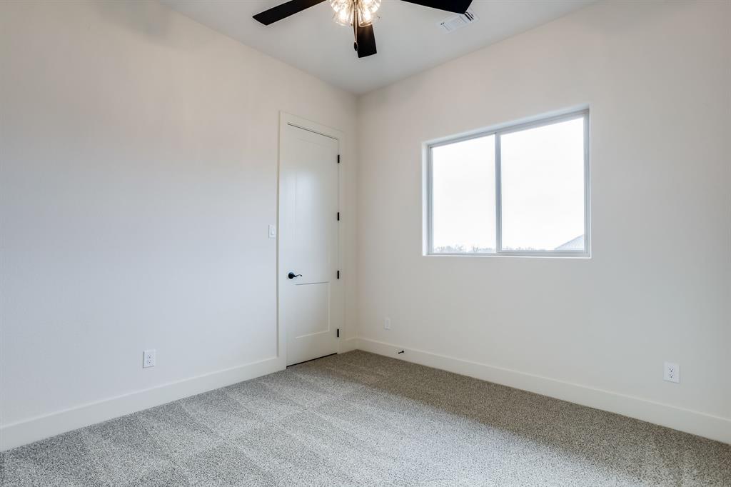 128 Prairie Winds Drive Poolville, TX 76487 - Photo 28 of 40 an empty room with a window and a kitchen