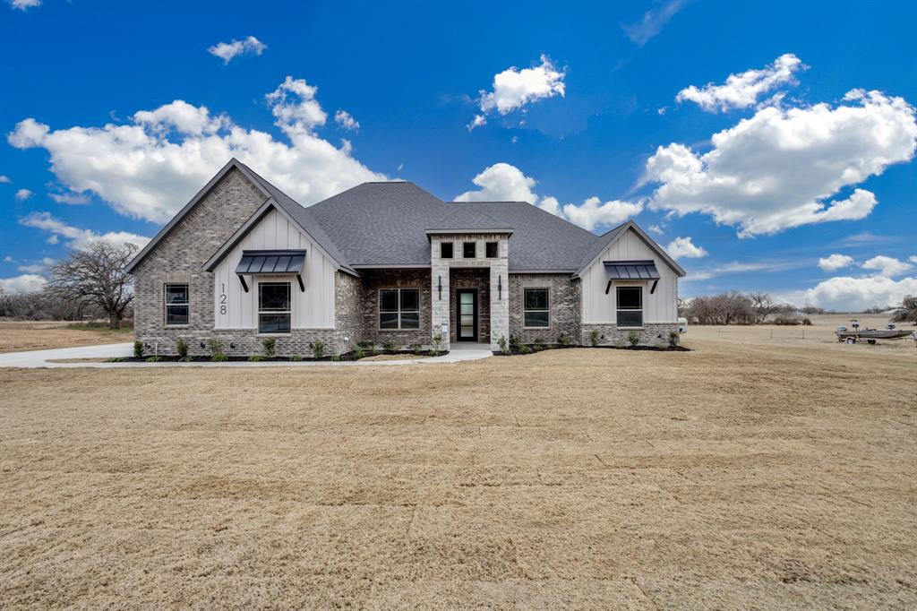 128 Prairie Winds Drive Poolville, TX 76487 - Photo 4 of 40 a view of a house with a yard