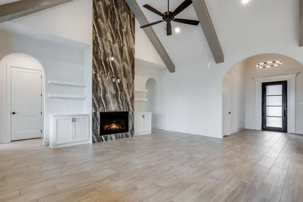 wooden floor in an empty room with a fireplace
