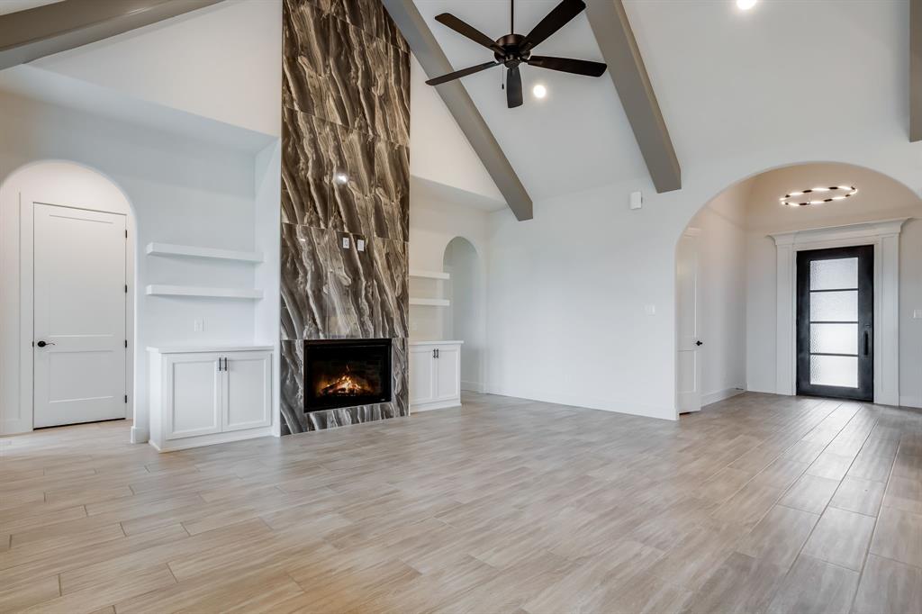 128 Prairie Winds Drive Poolville, TX 76487 - Photo 7 of 40 wooden floor in an empty room with a fireplace