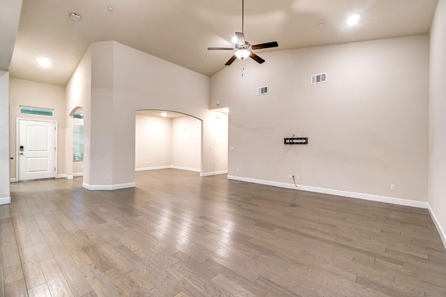 462 Crescent Lane Madera, CA 93636 - Photo 17 of 35 a view of an empty room with a window and wooden floor