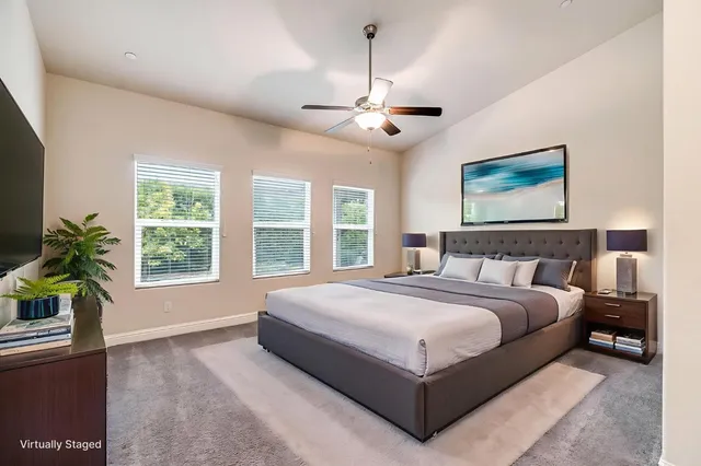 a spacious bedroom with a large bed and a window