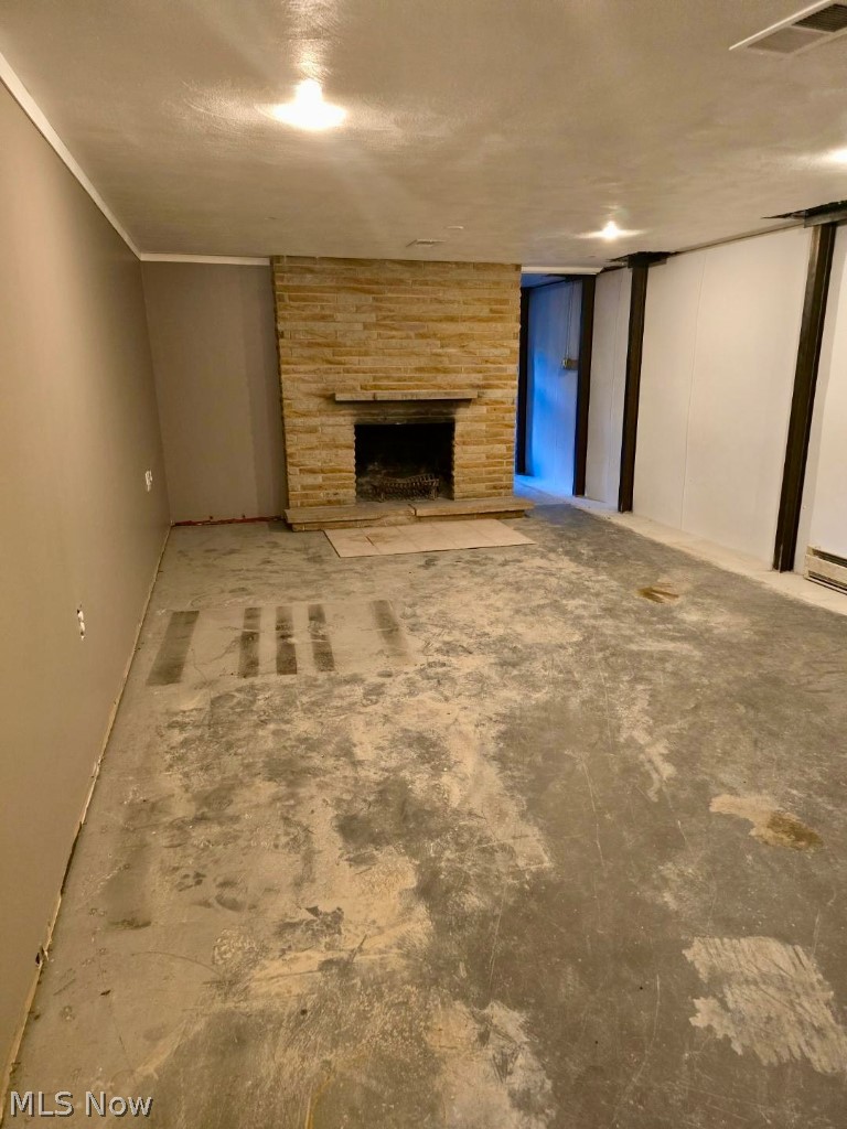 7735 Ragall Parkway Cleveland, OH 44130 - Photo 26 of 32 Unfurnished living room featuring a fireplace and a textured ceiling