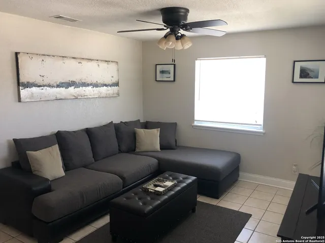 a view of a dining room with furniture and a kitchen