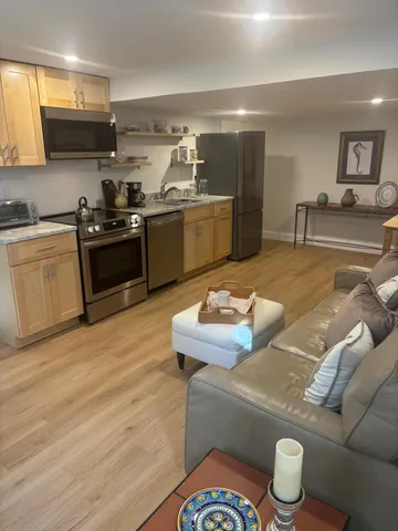 a kitchen with stainless steel appliances granite countertop a sink and a stove