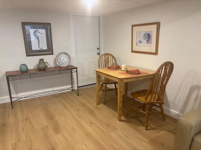 a view of a dining room with furniture and wooden floor