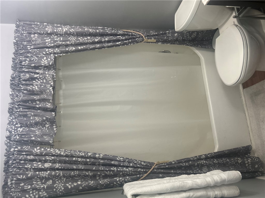 418 Saluda Road Williamston, SC 29697 - Photo 38 of 40 A well-maintained shower stall and toilet highlight this compact yet efficient bathroom space.