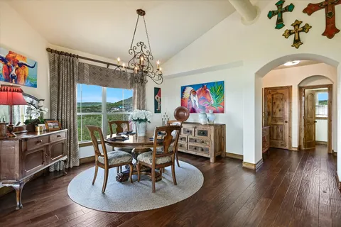 a view of a dining room with furniture wooden floor and chandelier