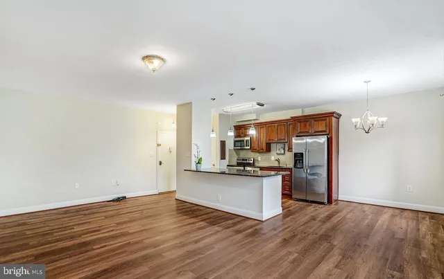 a kitchen with stainless steel appliances granite countertop a stove and a refrigerator