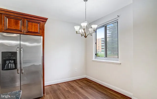 a kitchen with granite countertop a sink flowers in it