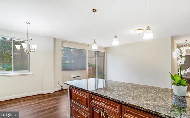 a spacious bathroom with a granite countertop sink and a mirror