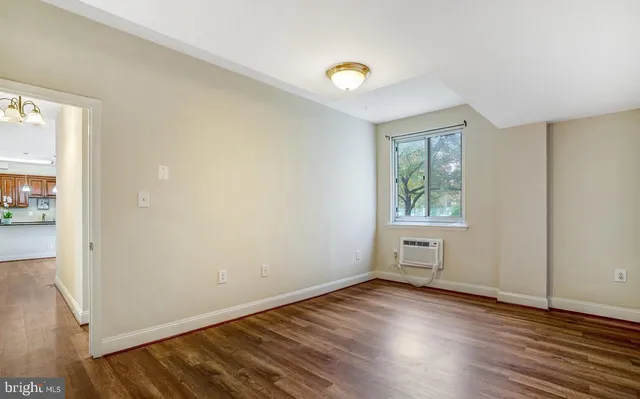 wooden floor in an empty room with a window