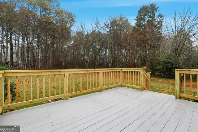 a view of a balcony with wooden floor and fence