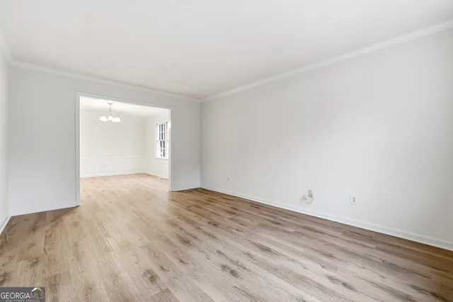 a view of an empty room and wooden floor