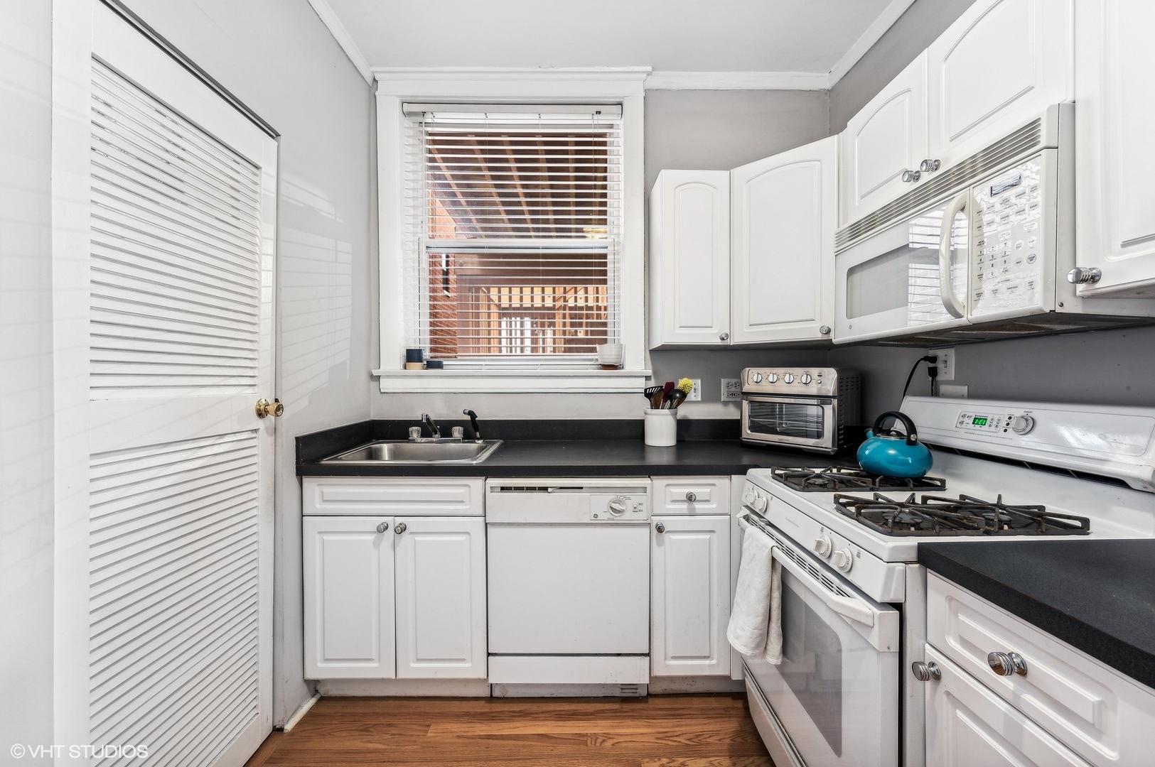 725 West Buckingham Place, Unit 2 Chicago, IL 60657 - Photo 9 of 15 a kitchen with stainless steel appliances granite countertop a sink stove and cabinets