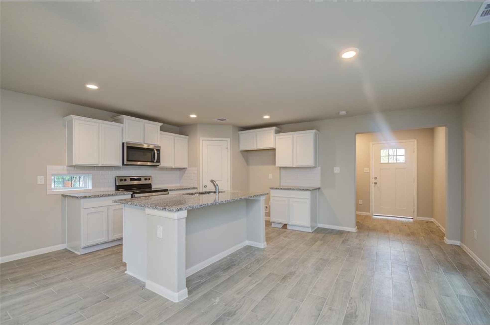 8209 Westcott Road Houston, TX 77016 - Photo 7 of 19 a kitchen with stainless steel appliances a white refrigerator a stove top oven a sink and cabinets