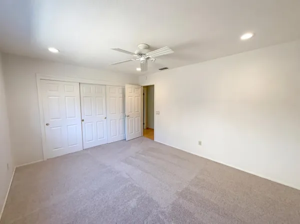 an empty room with fan and a ceiling fan