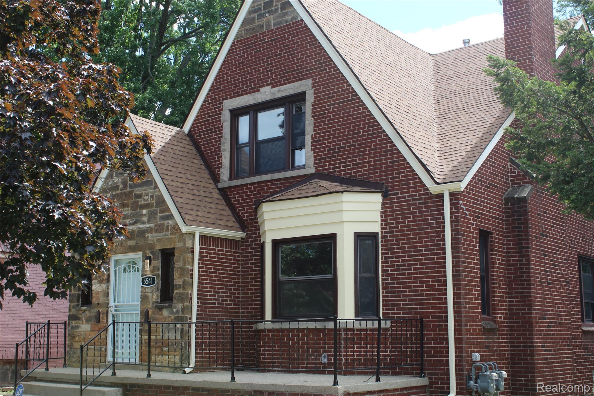 5543 Balfour Road Detroit, MI 48224 - Photo 2 of 54 Brick and stone-clad exterior featuring a prominent front bay window with light-colored siding