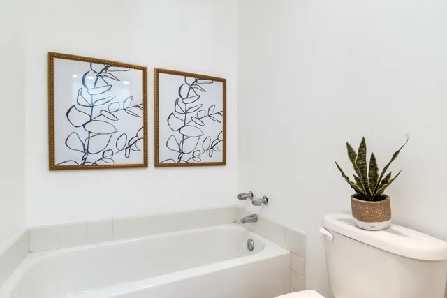 a white bath tub with a shower