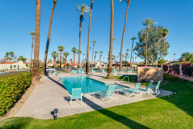 a view of a swimming pool with chairs