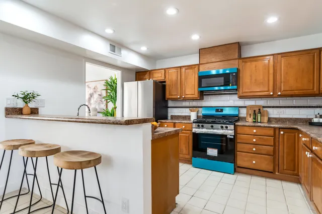 a kitchen with stainless steel appliances a stove a sink dishwasher and a refrigerator