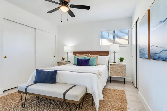 a bedroom with a bed and ceiling fan