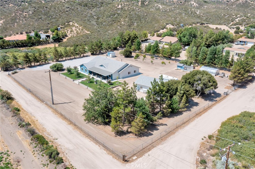 3798 Wells Road Hesperia, CA 92345 - Photo 1 of 1 an aerial view of a house with a yard and tennis court