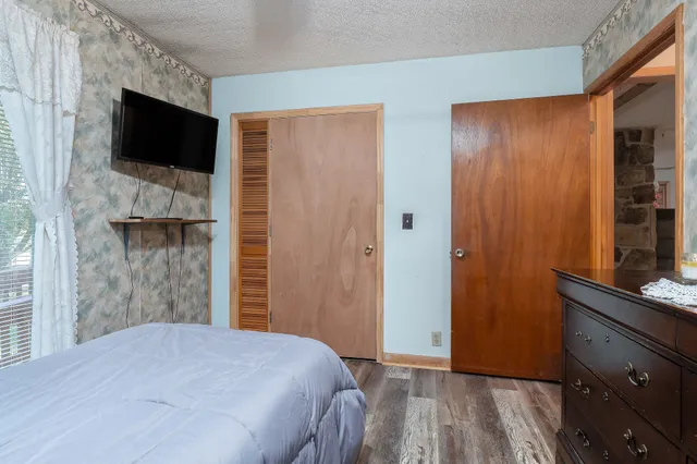 a work room with furniture a fireplace and a window