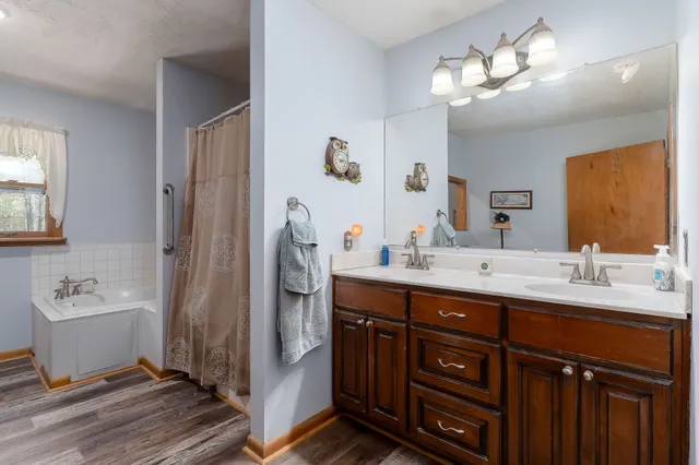 a living room with furniture a flat screen tv and a window