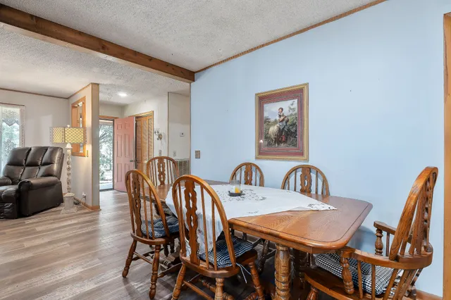 a view of a a dining room with furniture window and wooden floor