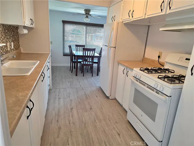 a kitchen with a stove and a refrigerator