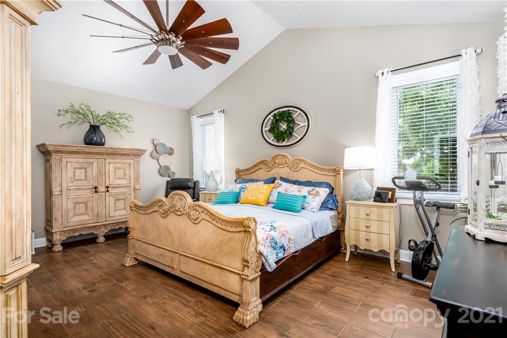 2515 Sandy Ford Road Newton, NC 28658 - Photo 16 of 38 a bedroom with a bed and a chandelier