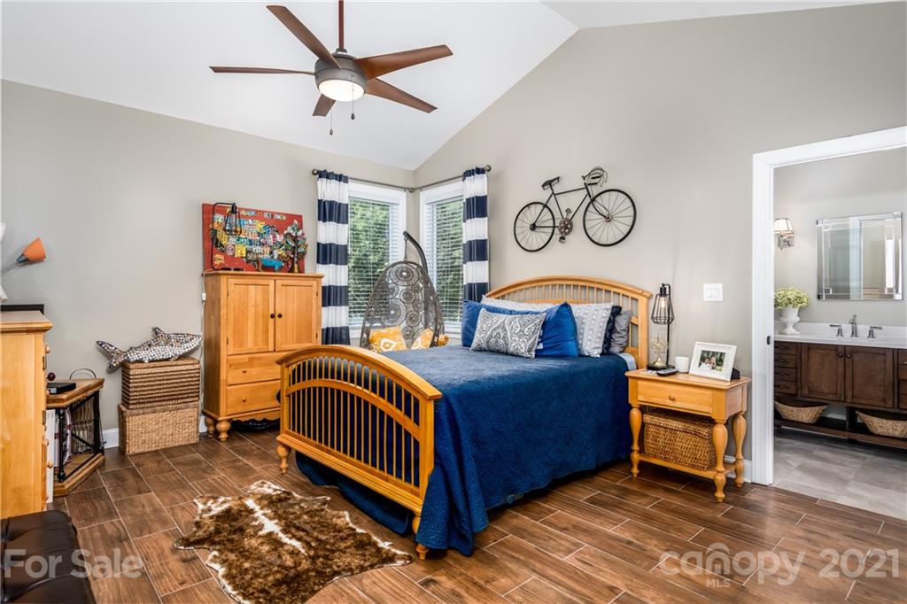 2515 Sandy Ford Road Newton, NC 28658 - Photo 26 of 38 a bedroom with a bed and a chandelier