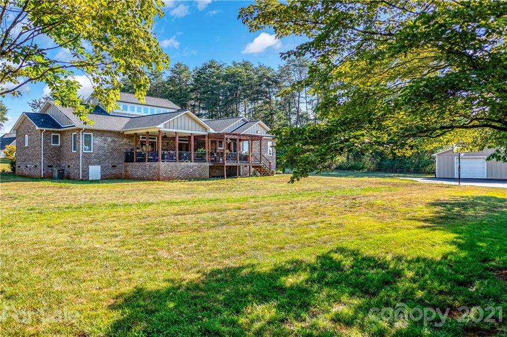 2515 Sandy Ford Road Newton, NC 28658 - Photo 33 of 38 a view of a house with a big yard and large trees