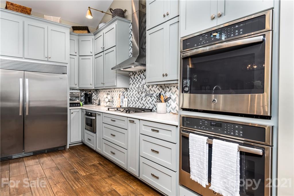 2515 Sandy Ford Road Newton, NC 28658 - Photo 7 of 38 a kitchen with stainless steel appliances granite countertop a stove a microwave and a refrigerator