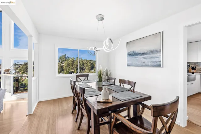 a dining room with a wooden table and chairs