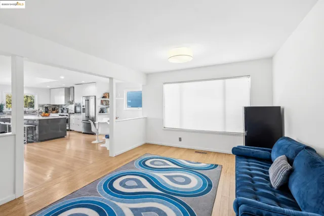 a spacious bedroom with a bed and glass window