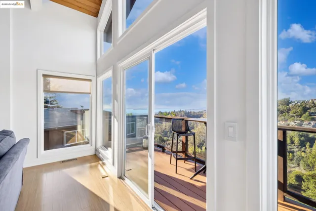a view of a hallway with wooden floor and dining room