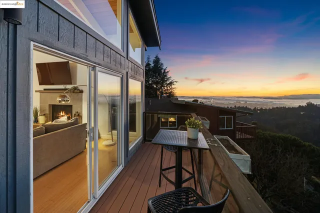 a view of a balcony with chairs and wooden floor