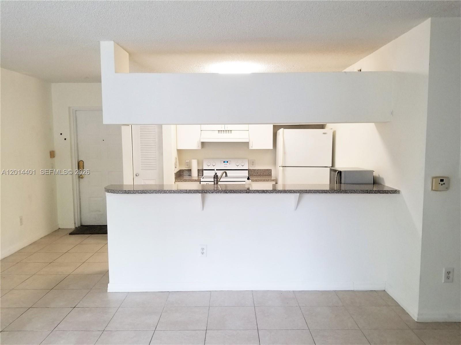 470 South Park Road, Unit 7110 Hollywood, FL 33021 - Photo 2 of 18 a view of a kitchen with kitchen island and stainless steel appliances