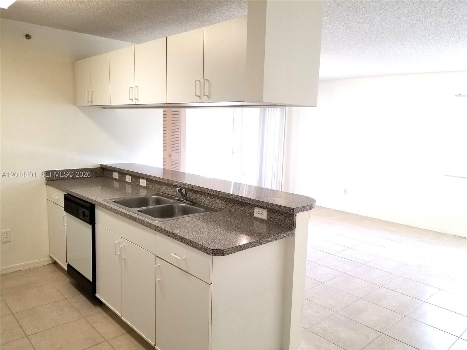 470 South Park Road, Unit 7110 Hollywood, FL 33021 - Photo 7 of 18 a kitchen with granite countertop a sink and a stove