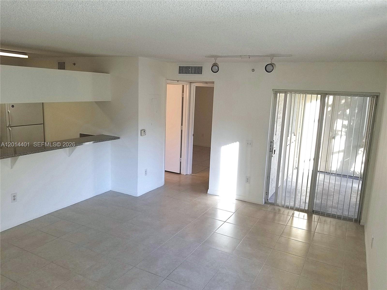 470 South Park Road, Unit 7110 Hollywood, FL 33021 - Photo 9 of 18 a view of an empty room with wooden floor and a window