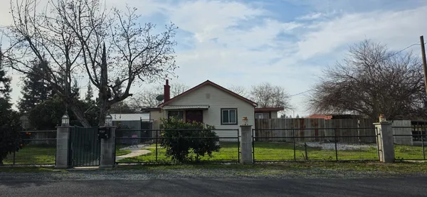 a front view of house with wooden fence