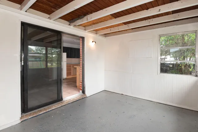 a view of a room with wooden floor and windows