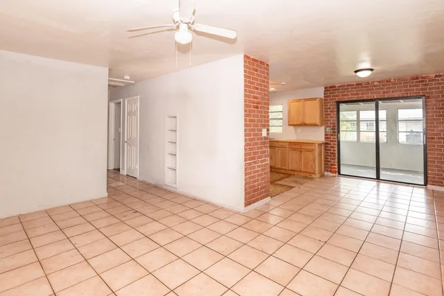 a view of a refrigerator and window in a kitchen