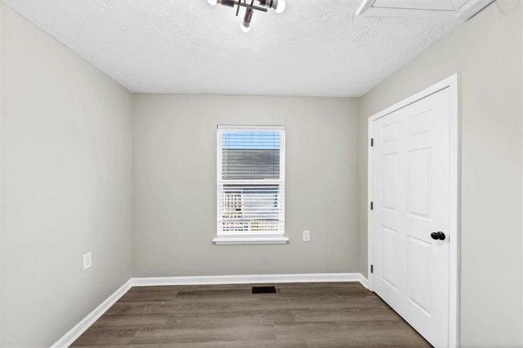 2478 Verbena Circle Northwest Atlanta, GA 30314 - Photo 18 of 42 a view of an empty room with wooden floor and a window